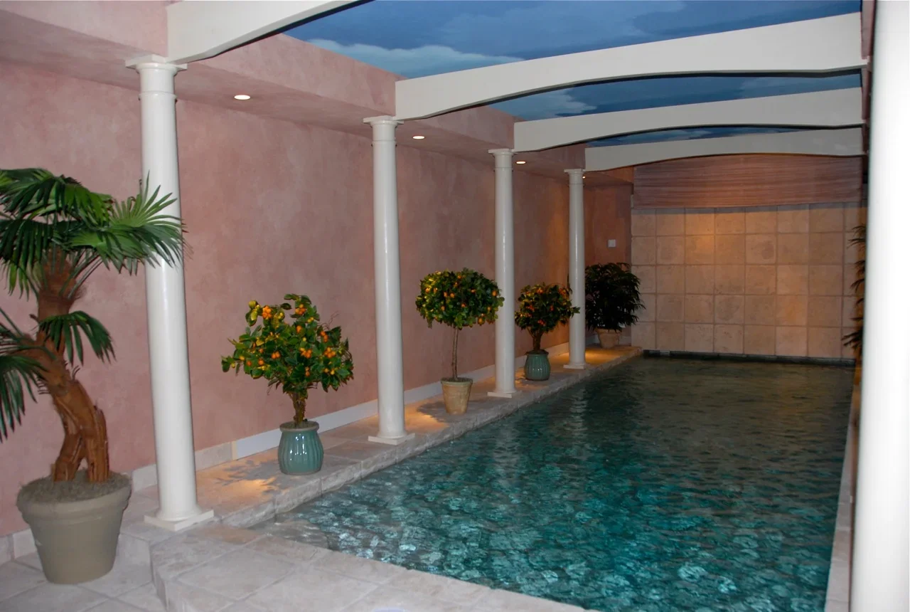 Engaged consultation between custom home builder and clients, exemplifying personalized custom home building process in a sophisticated office with detailed plans and material samples.