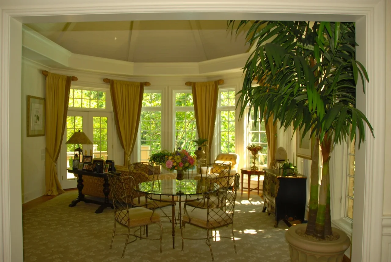 Elegant open-concept living space inside a custom home, illustrating architectural integrity and residential craftsmanship with natural materials, custom details, and panoramic windows.